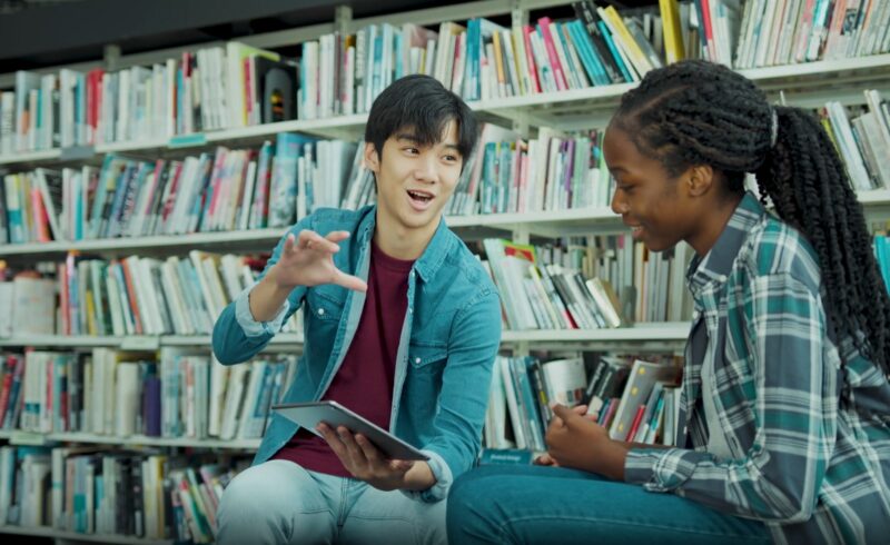 students talking in library 